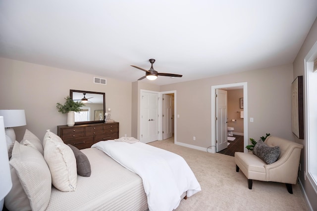 carpeted bedroom featuring ensuite bathroom and ceiling fan