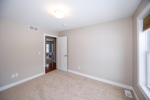 unfurnished bedroom featuring light colored carpet