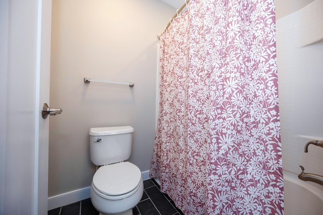 bathroom featuring toilet, curtained shower, and tile patterned flooring