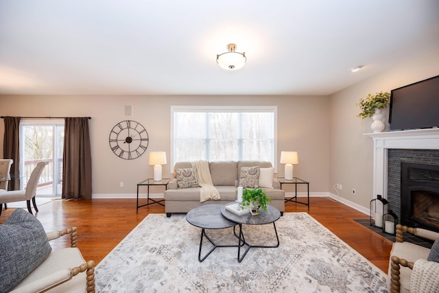 living room featuring hardwood / wood-style floors and a tile fireplace