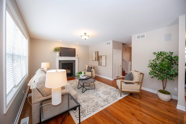 living room with hardwood / wood-style floors and a fireplace