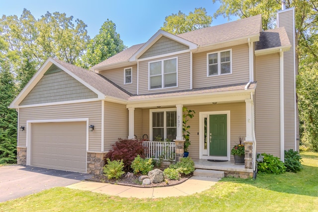 craftsman house with a garage, a porch, and a front lawn