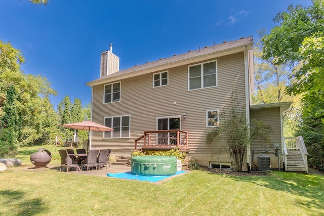 back of house featuring a patio, central AC unit, a deck, and a lawn