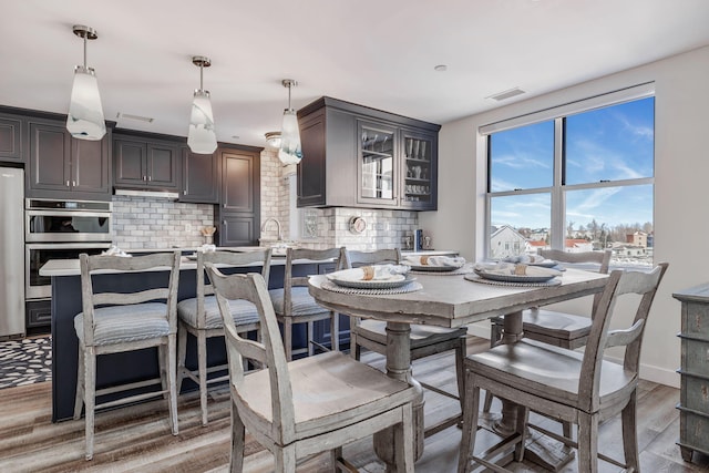 dining space with hardwood / wood-style floors