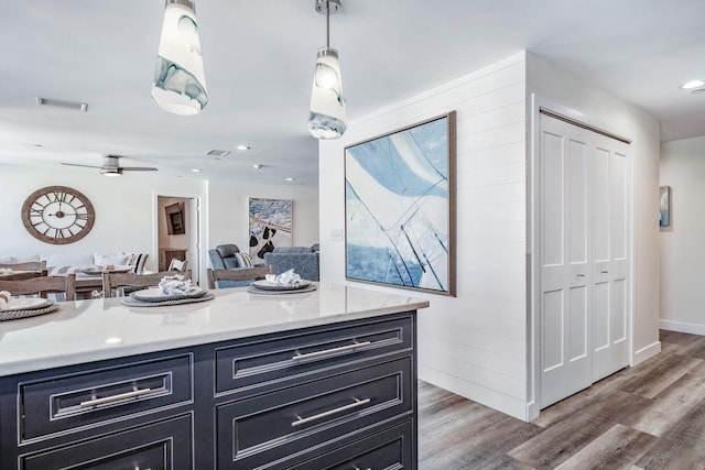 interior space with vanity, wood-type flooring, and ceiling fan