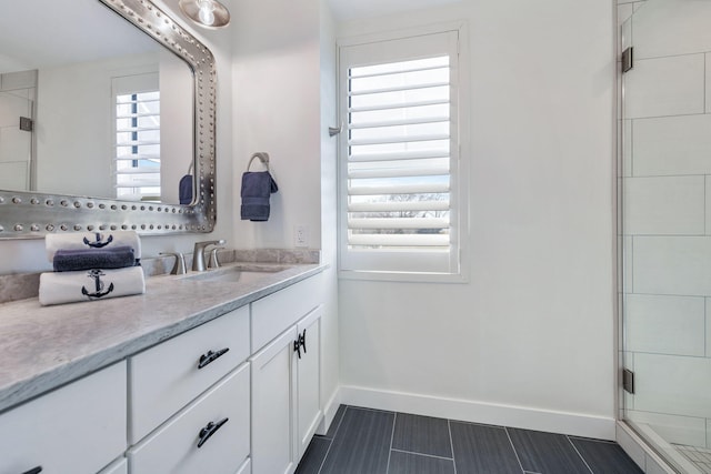 bathroom with walk in shower and vanity