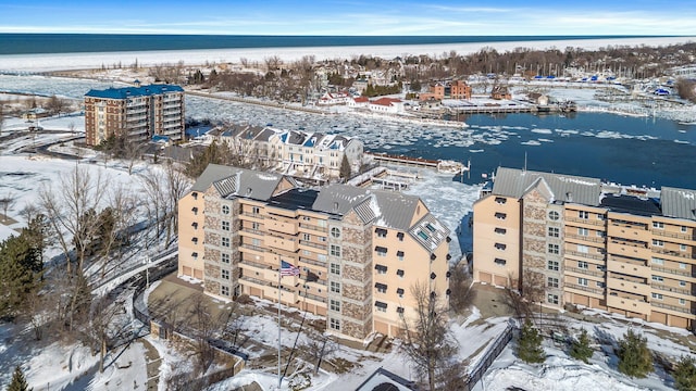 snowy aerial view featuring a water view