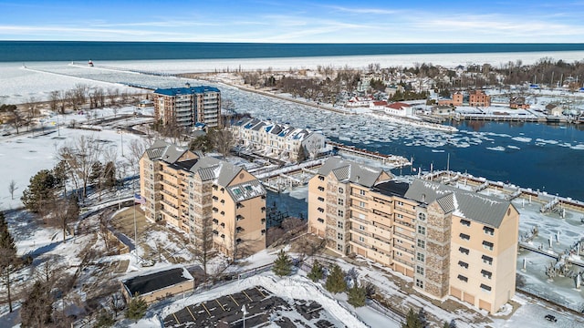 snowy aerial view with a water view