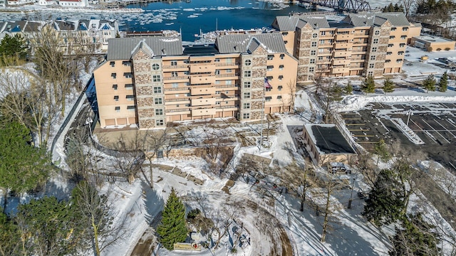 snowy aerial view with a water view