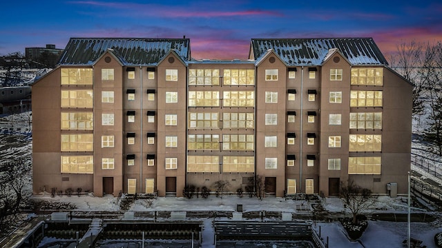 view of outdoor building at dusk