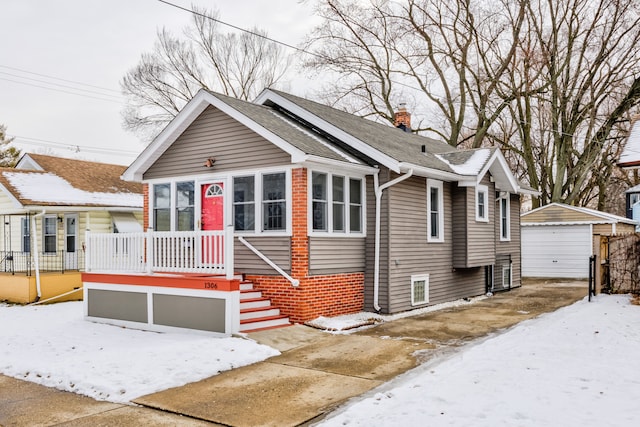 bungalow-style home with a garage, roof with shingles, and a chimney