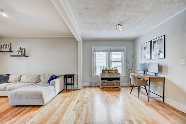 interior space featuring ornamental molding, visible vents, baseboards, and wood finished floors