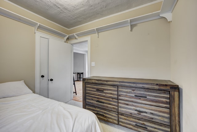 bedroom with a closet and a textured ceiling