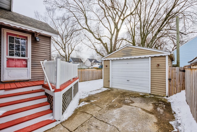 detached garage with driveway and fence