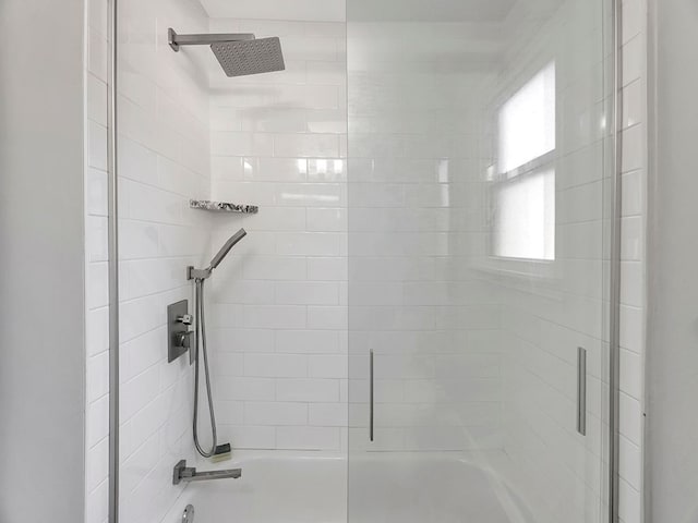 bathroom featuring bath / shower combo with glass door