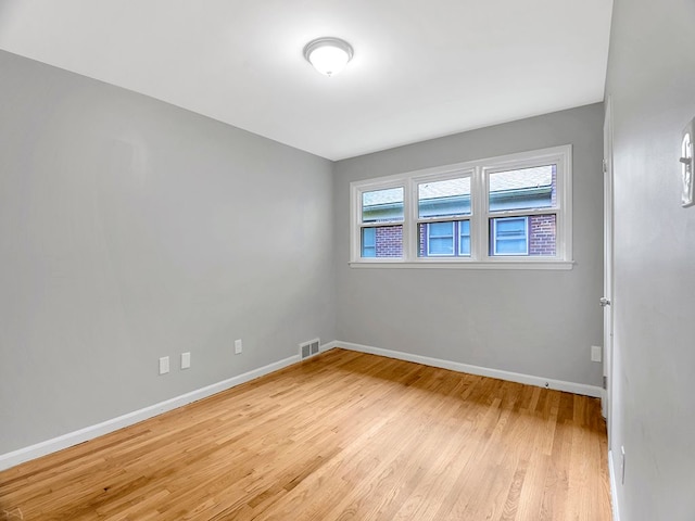 spare room featuring light hardwood / wood-style flooring