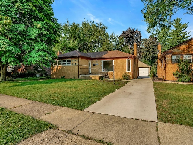 view of front of property with a garage, an outbuilding, and a front yard