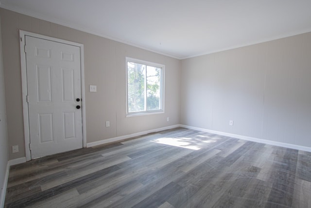 empty room with dark wood-type flooring and ornamental molding