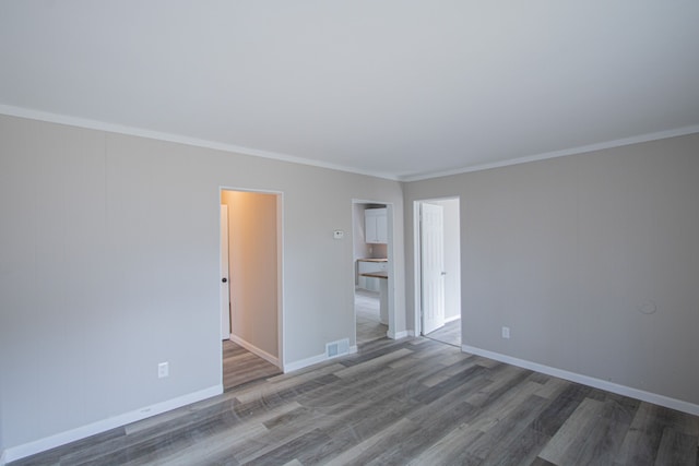 unfurnished room with hardwood / wood-style flooring and ornamental molding