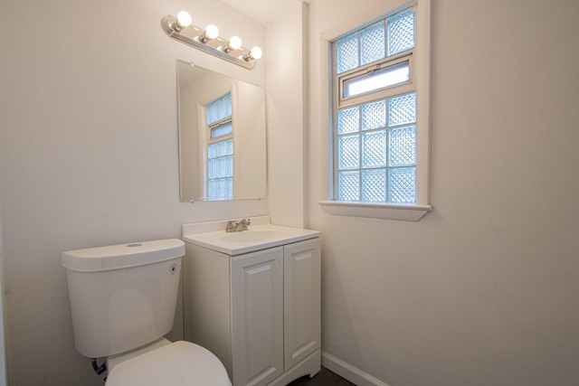 bathroom with vanity, a wealth of natural light, and toilet