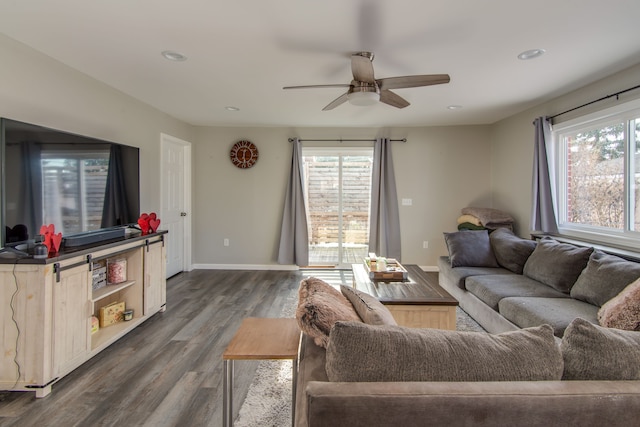 living room featuring dark wood-type flooring and ceiling fan