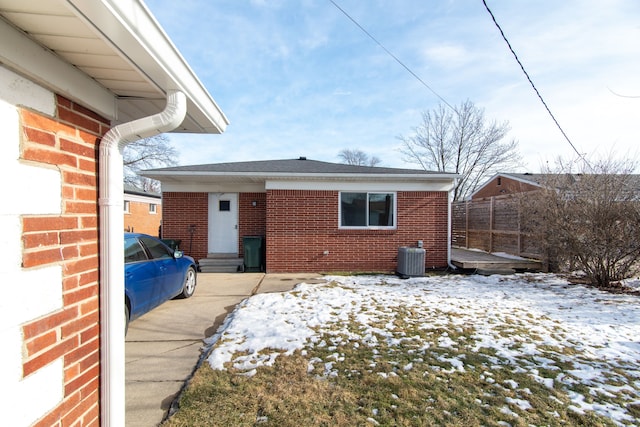 snow covered property featuring central air condition unit