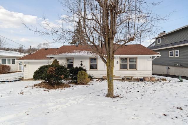 view of snow covered rear of property