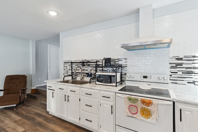 kitchen with wall chimney exhaust hood, sink, tasteful backsplash, white appliances, and white cabinets