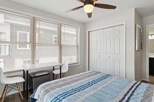 bedroom with dark wood-type flooring, a closet, and ceiling fan