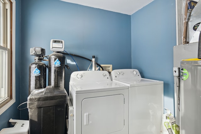 laundry area with independent washer and dryer and electric water heater