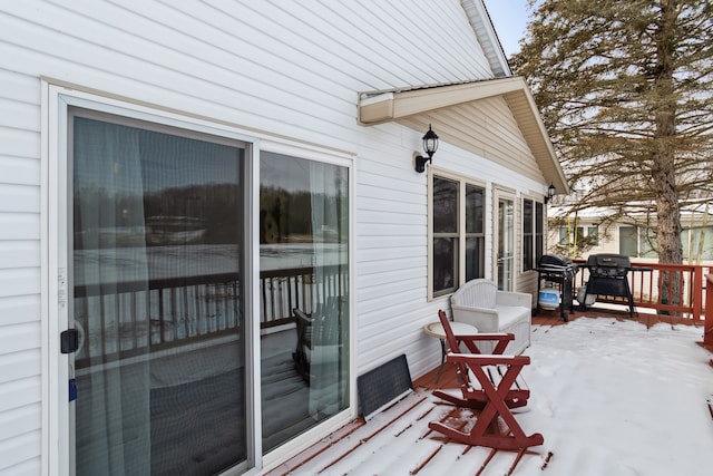 snow covered deck with area for grilling