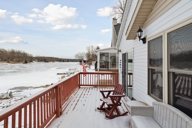 snow covered deck with a sunroom