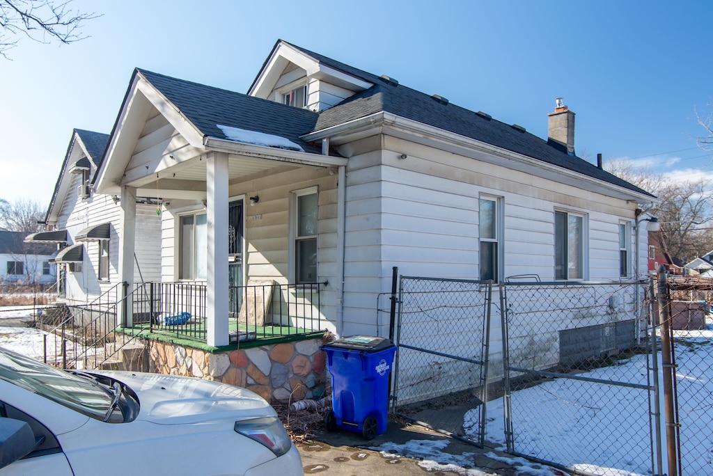 view of side of home with a porch