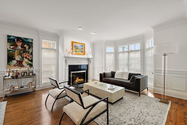 living room with hardwood / wood-style flooring and ornamental molding