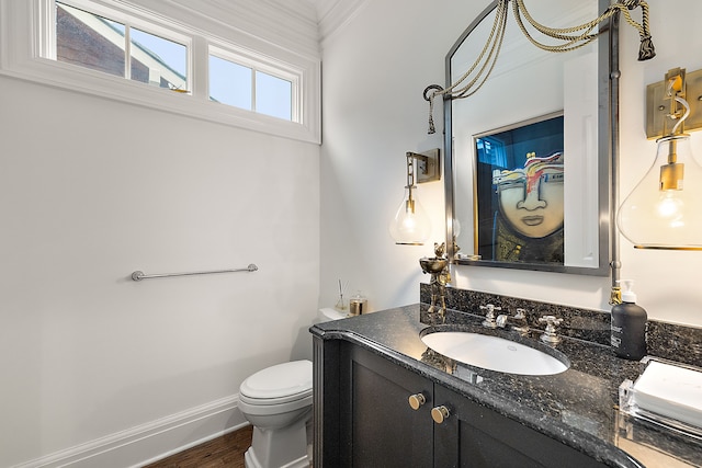 bathroom with hardwood / wood-style flooring, vanity, and toilet