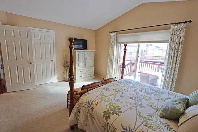 bedroom featuring vaulted ceiling, carpet, and access to outside