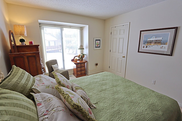 bedroom with a textured ceiling and carpet