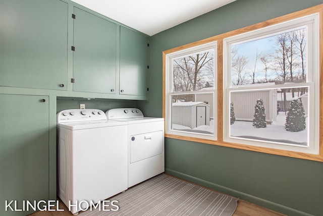 laundry room with cabinets and separate washer and dryer