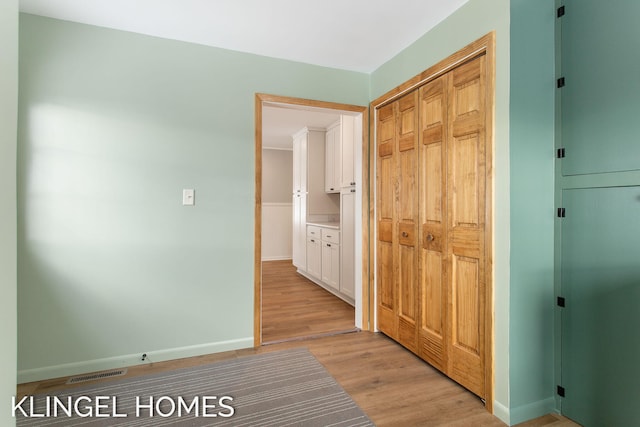 corridor with light hardwood / wood-style flooring