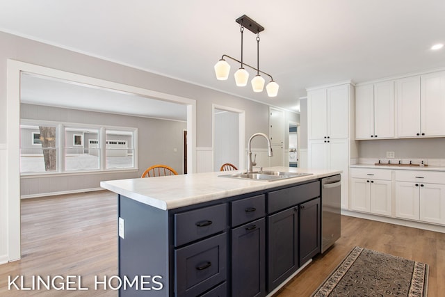 kitchen with white cabinetry, a kitchen island with sink, dishwasher, and sink