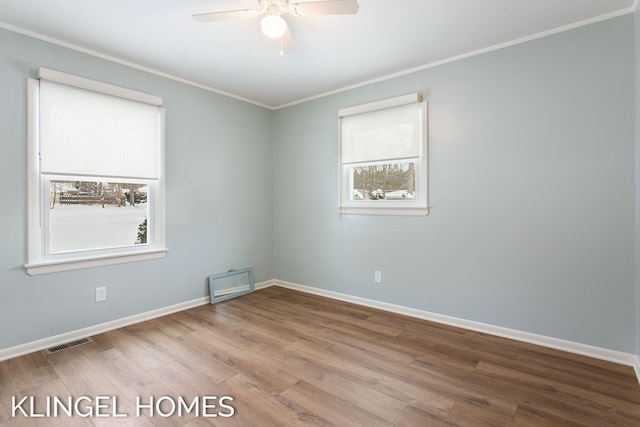 unfurnished room with ornamental molding, ceiling fan, and light wood-type flooring