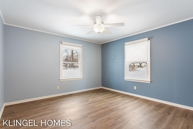 empty room with wood-type flooring, ceiling fan, and crown molding