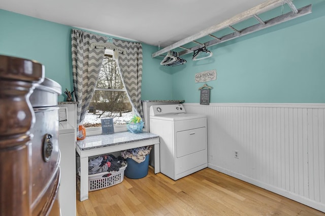 laundry room with washer / clothes dryer and light hardwood / wood-style floors