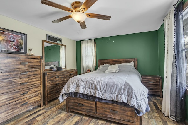 bedroom with dark wood-type flooring and ceiling fan