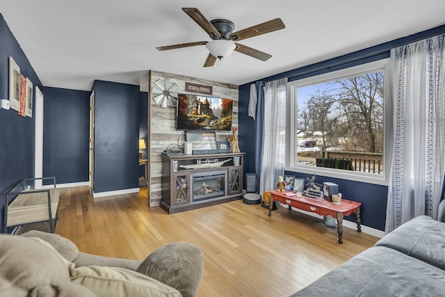 living room with ceiling fan and hardwood / wood-style floors