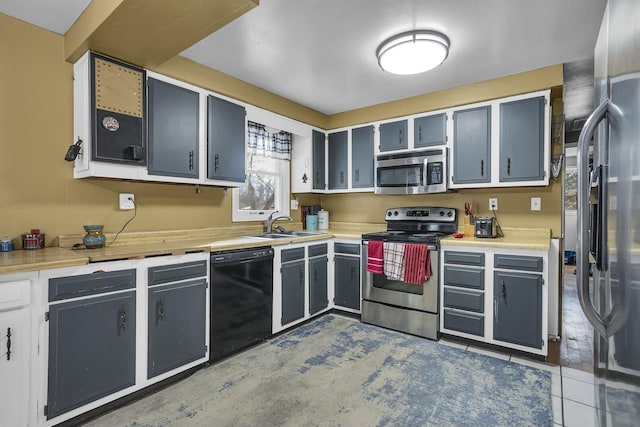 kitchen featuring stainless steel appliances, sink, and light tile patterned floors