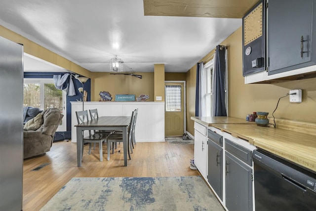 kitchen featuring dishwasher and light wood-type flooring