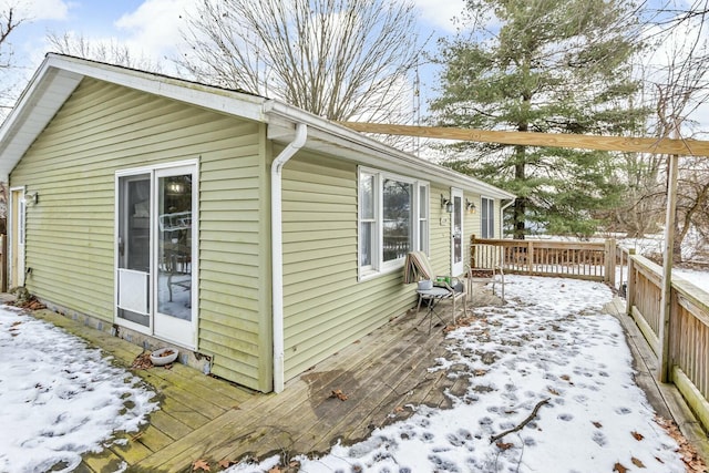 view of snowy exterior with a deck