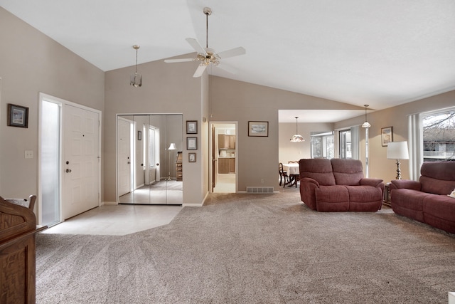 carpeted living room featuring high vaulted ceiling and ceiling fan