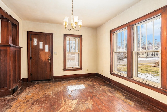 foyer with a notable chandelier and dark wood-type flooring